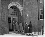 Students exiting and entering Fraser Hall in the winter by SUNY Geneseo